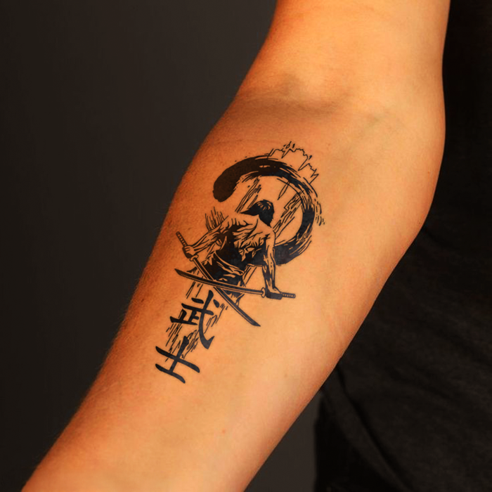 Black tattoo of a warrior on an arm against a dark background