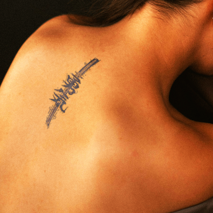 Tattoo on a person's shoulder with a dark background